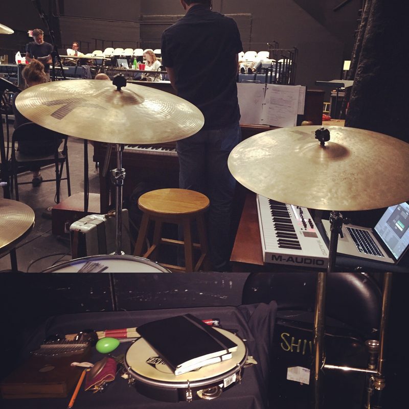 Cymbals, keyboards and percussion in a theatre pit at rehearsal